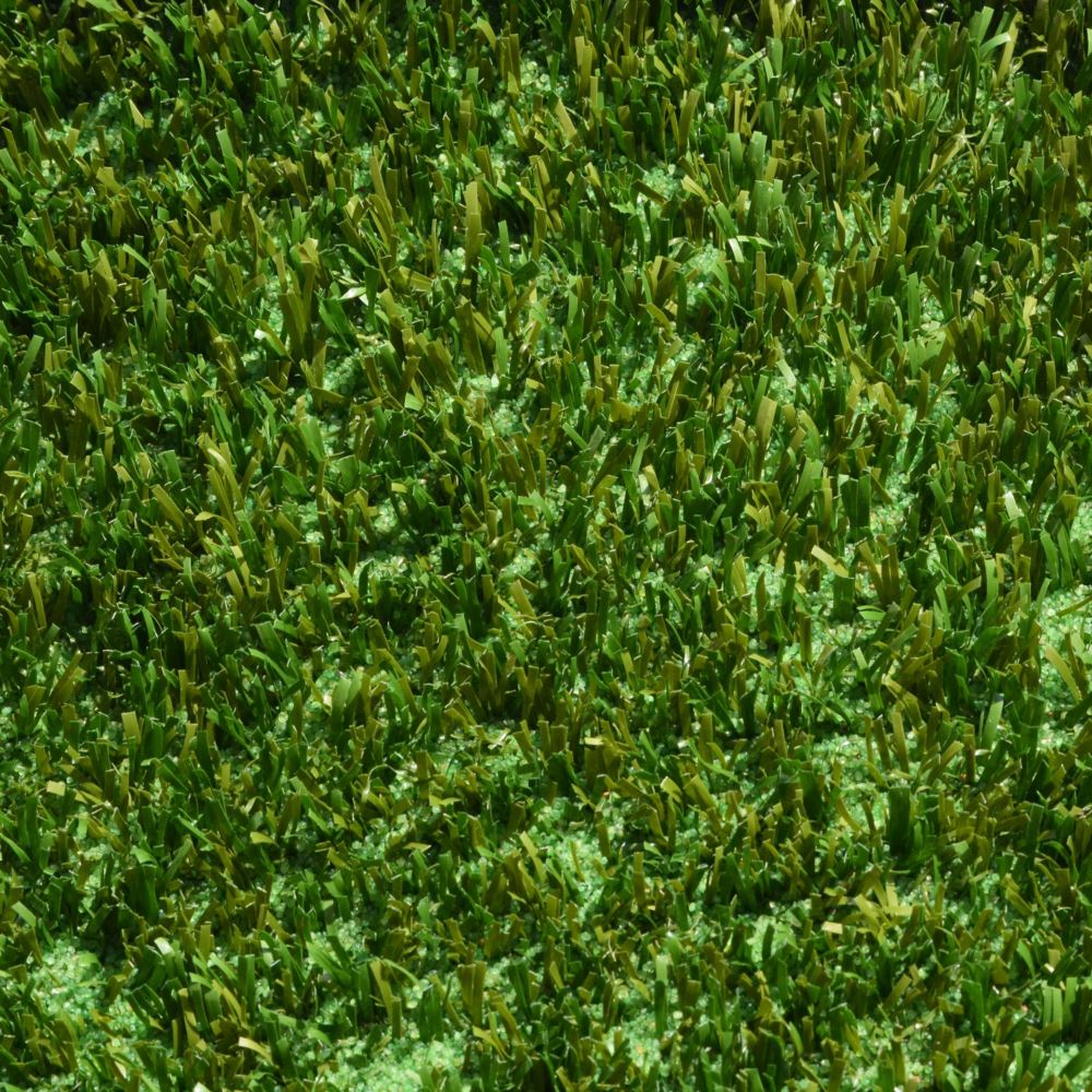 A close up shot of artificial turf designed for playgrounds featuring short green and brown grass strands A close up shot of artificial turf designed for playgrounds featuring short green and brown grass strands