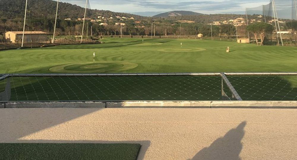 Synthetic turf beside natural grass golf course
