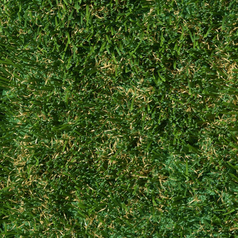 A close up image of artificial grass that is green with some brown. A close up image of artificial grass that is green with some brown.