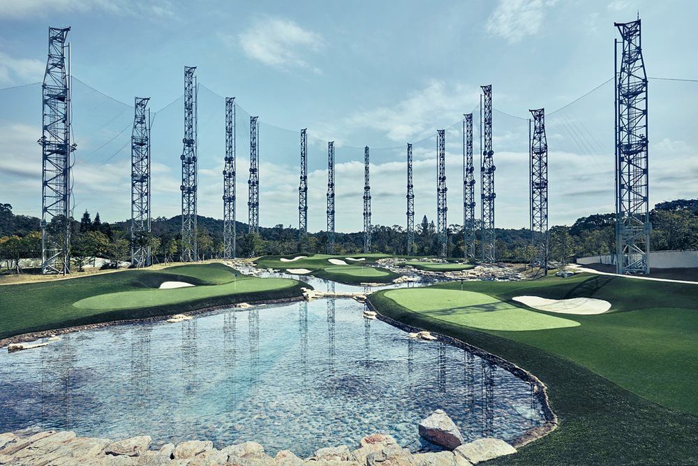 Synthetic grass golf course with water and tall metal towers