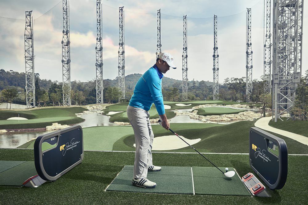 Golfer on synthetic grass tee box