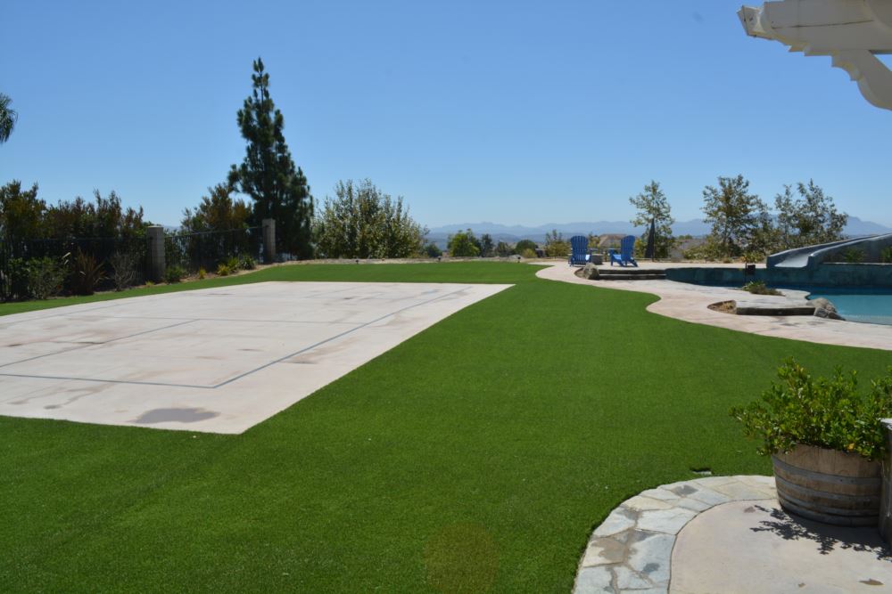 Synthetic grass installation creating a pristine backyard