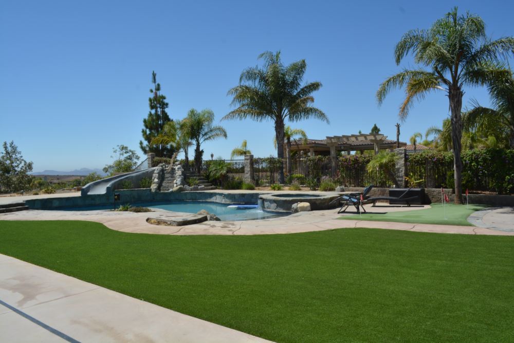 Synthetic grass installation creating a pristine backyard
