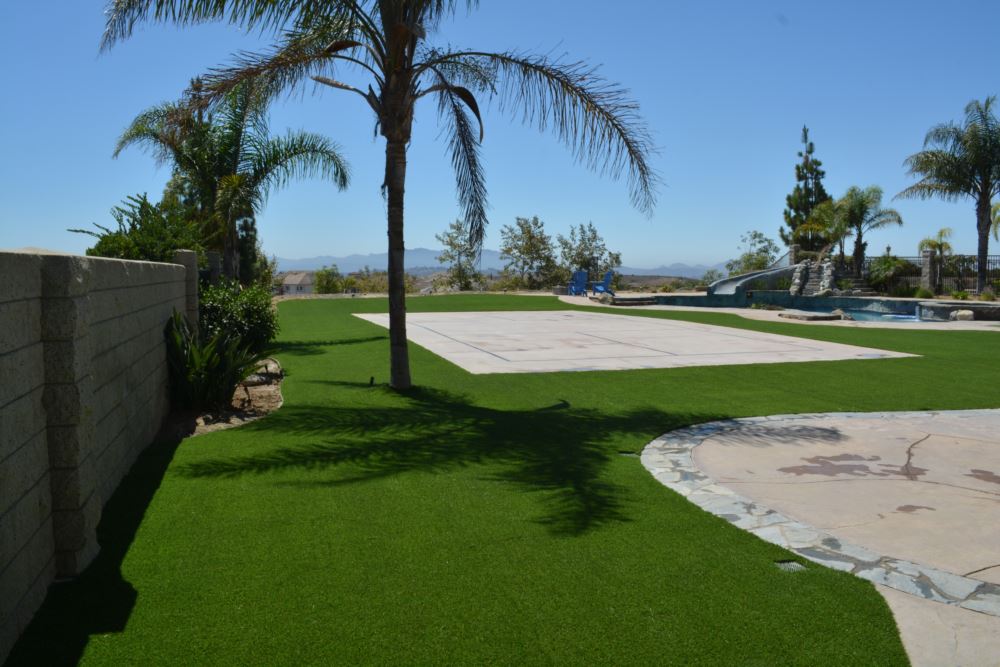 Synthetic grass installation creating a pristine backyard